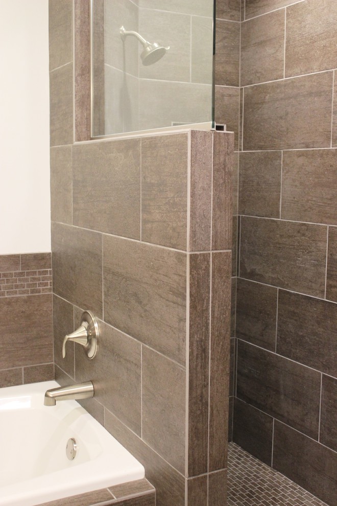 Design ideas for a transitional bathroom in Chicago with dark wood cabinets, a drop-in tub, an open shower, gray tile, ceramic tile, ceramic floors and an integrated sink.