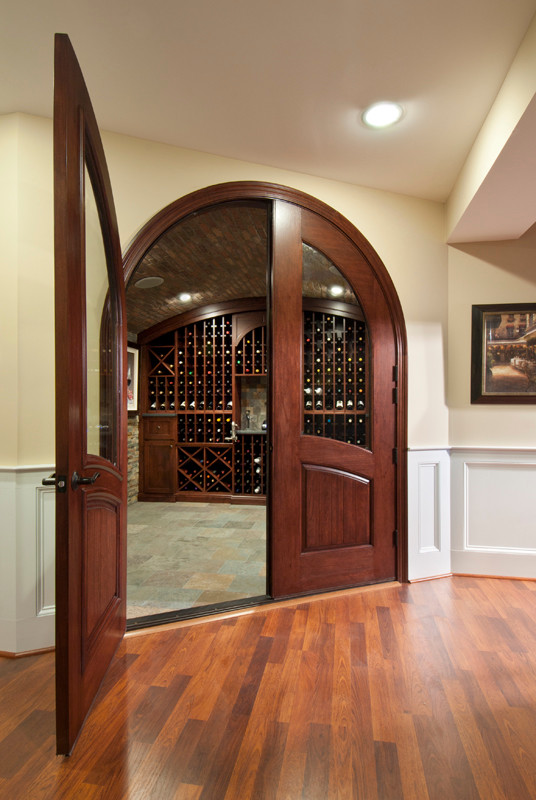 Mid-sized country wine cellar in Philadelphia with slate floors and diamond bins.