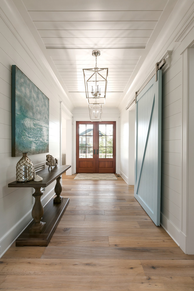 Design ideas for a beach style entry hall in Charleston with beige floor.