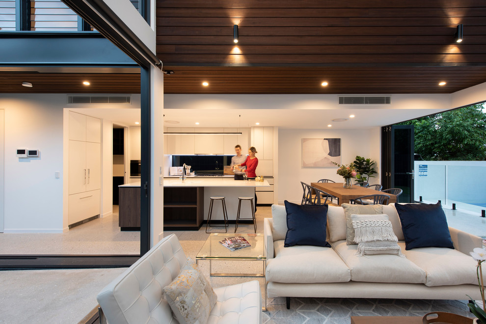 Photo of a mid-sized contemporary open plan dining in Brisbane with beige walls, concrete floors and grey floor.