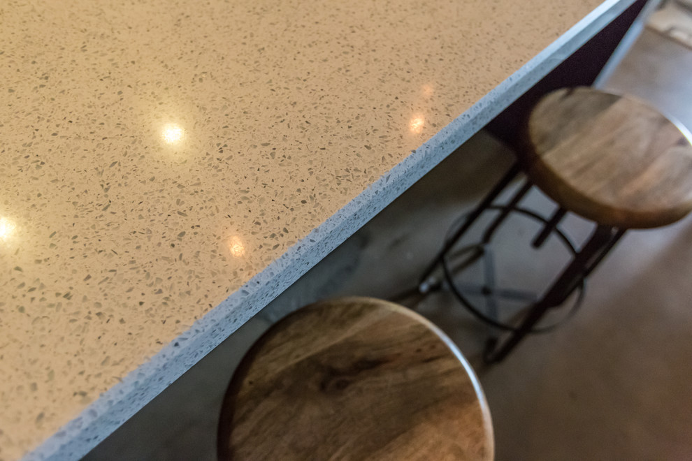 Mid-sized mountain style single-wall concrete floor and gray floor open concept kitchen photo in Phoenix with an undermount sink, shaker cabinets, dark wood cabinets, blue backsplash, stainless steel appliances, an island, quartzite countertops and glass tile backsplash