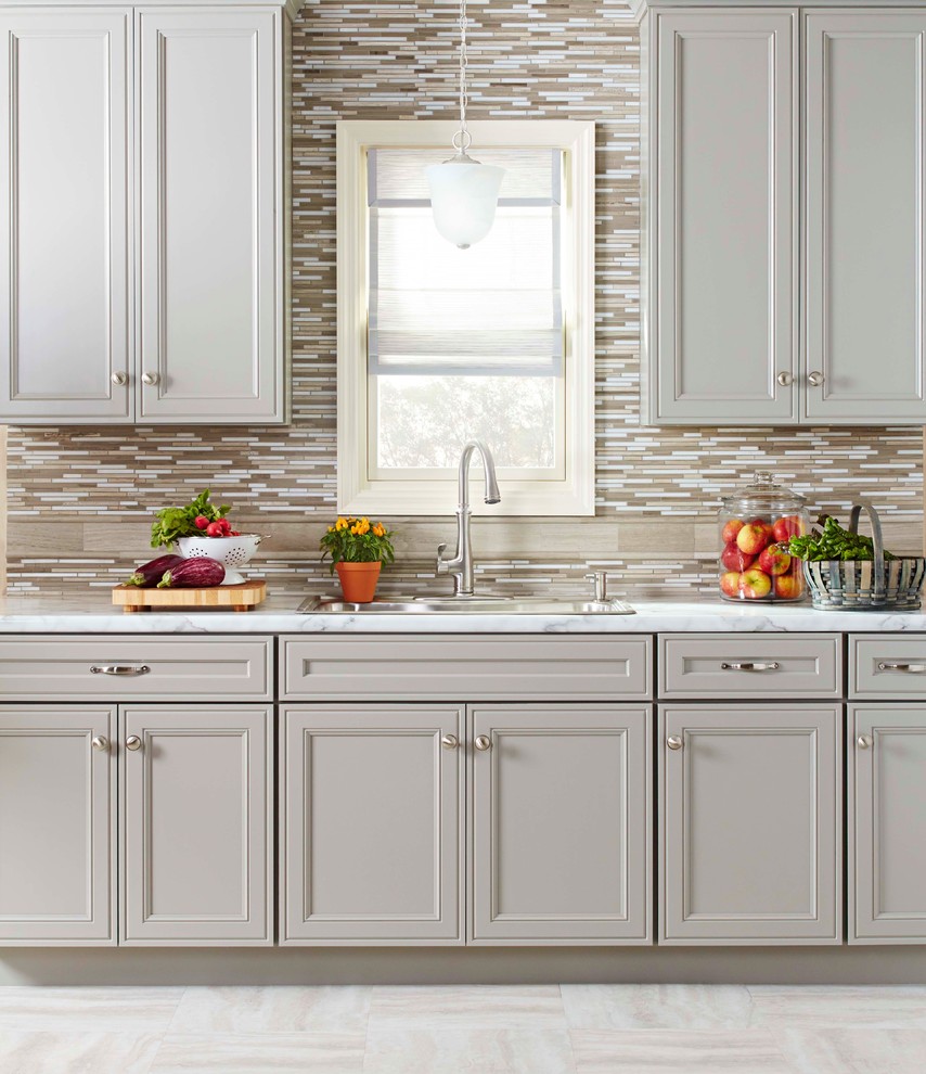 Transitional single-wall open concept kitchen photo in Charlotte with beige backsplash, stainless steel appliances, laminate countertops and gray cabinets