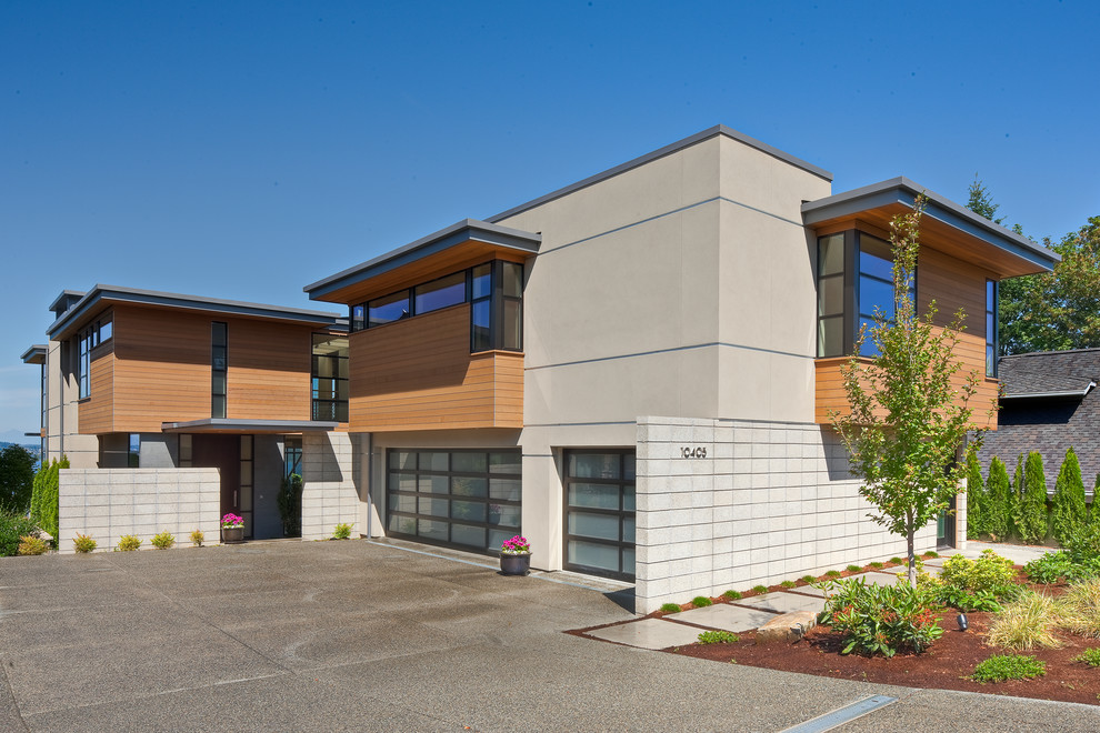 This is an example of a contemporary two-storey beige exterior in Seattle with mixed siding.