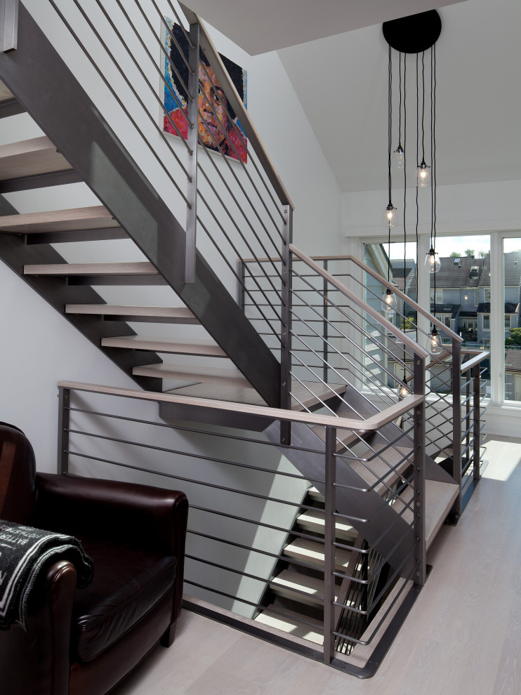 Contemporary wood floating staircase in Baltimore with open risers and metal railing.