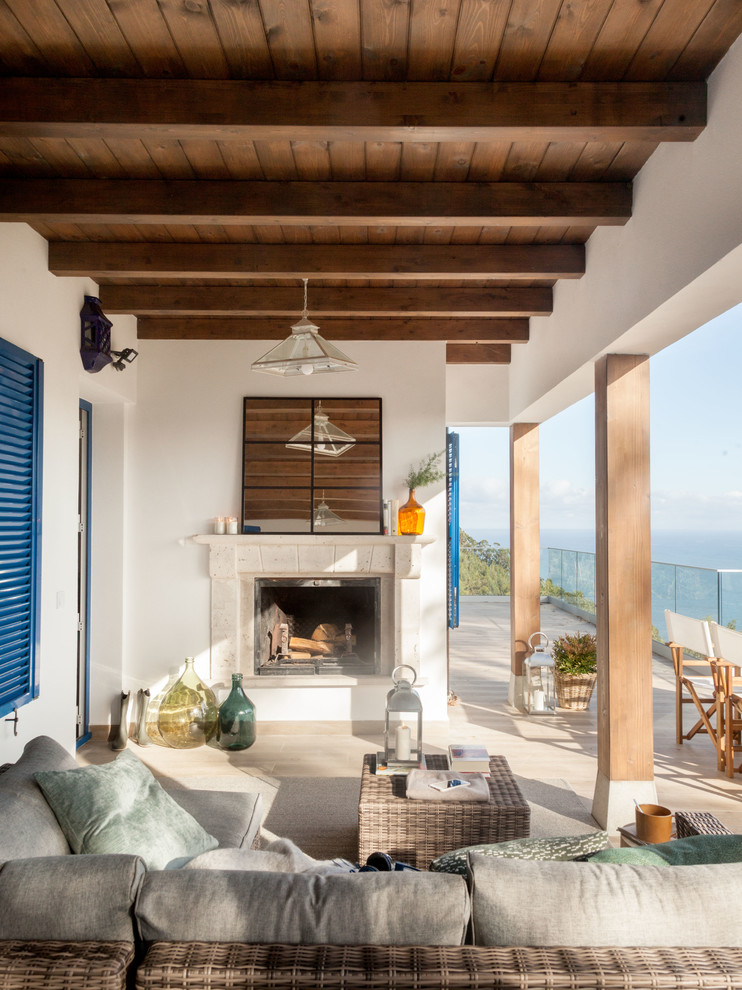 Inspiration for a beach style deck in Other with with fireplace and a roof extension.