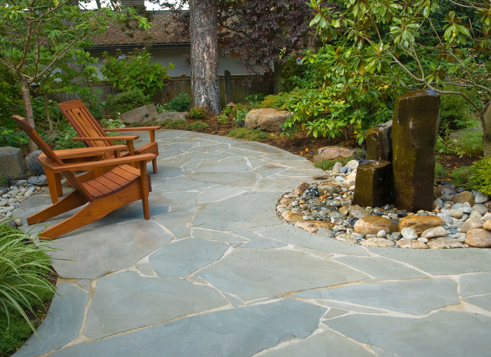 Design ideas for a traditional front yard stone water fountain landscape in Seattle.