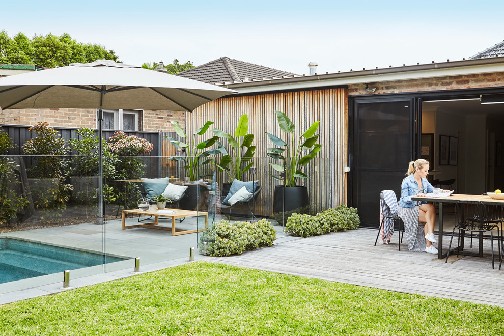 This is an example of a mid-sized contemporary backyard patio in Sydney with tile.