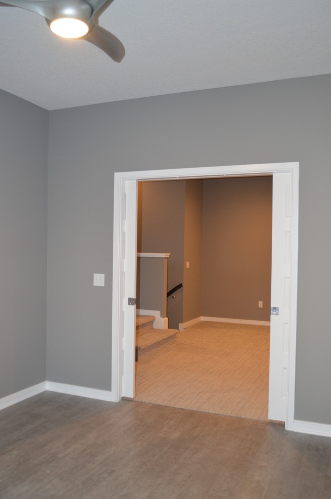 Photo of a mid-sized modern study room in Other with grey walls, laminate floors and grey floor.