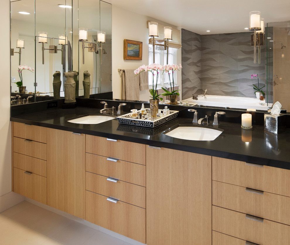 Tuscan gray tile bathroom photo in Santa Barbara with an undermount sink, flat-panel cabinets and light wood cabinets