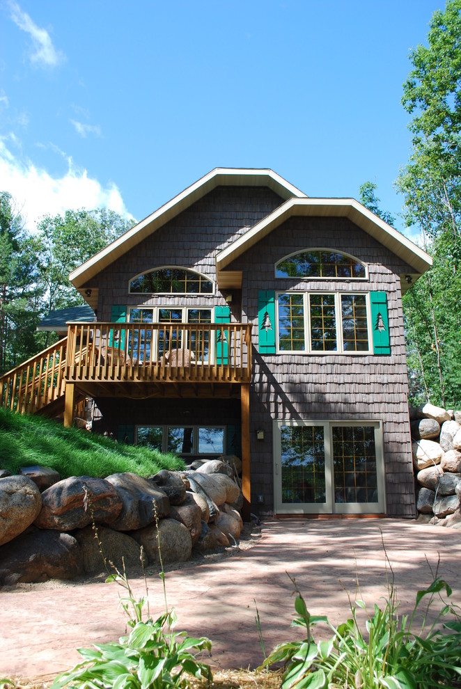 Photo of a mid-sized transitional partial sun front yard concrete paver retaining wall landscape for summer.
