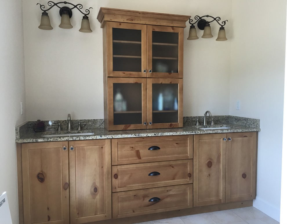 Inspiration for a rustic master porcelain tile bathroom remodel in Jacksonville with shaker cabinets, medium tone wood cabinets, beige walls, an undermount sink and granite countertops