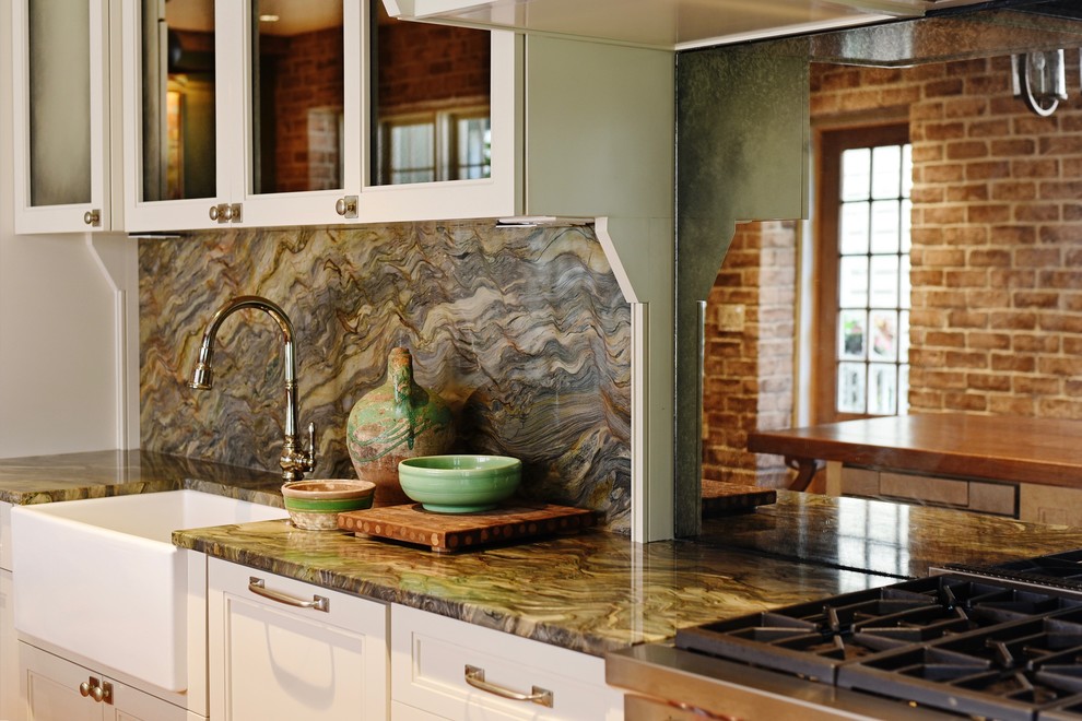 This is an example of a mid-sized traditional single-wall kitchen in Charleston with a farmhouse sink, flat-panel cabinets, white cabinets, granite benchtops, green splashback, mirror splashback, stainless steel appliances, medium hardwood floors, with island, brown floor and green benchtop.