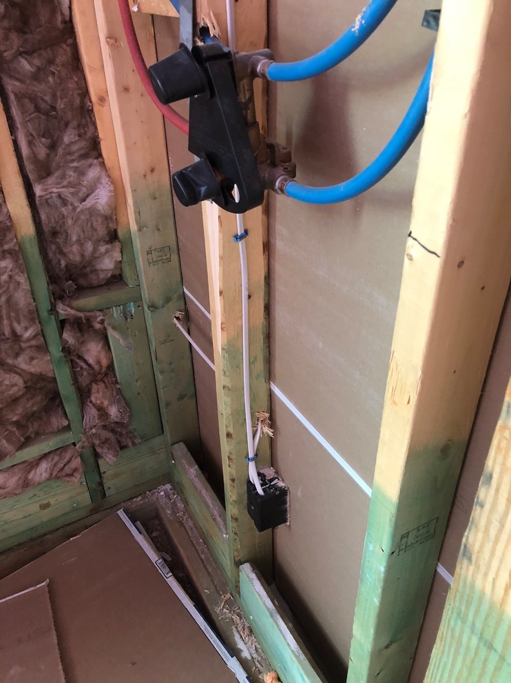 Outlet behind shower wall