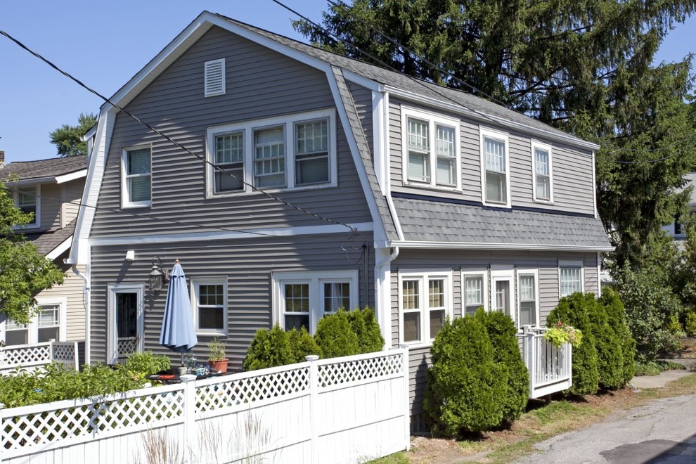 Design ideas for a beach style two-storey grey exterior in Columbus with vinyl siding.