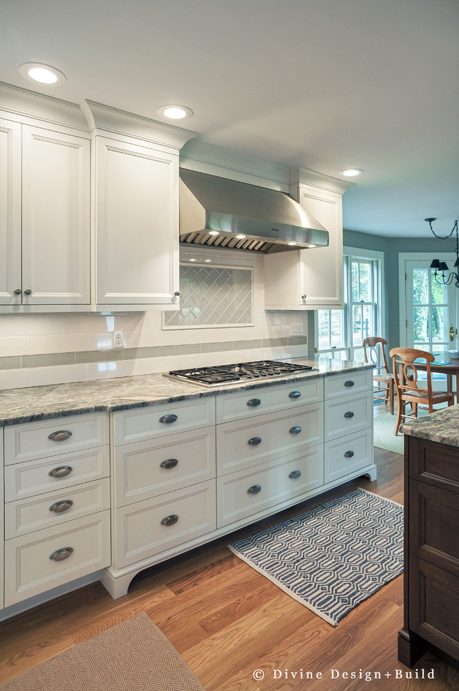 Design ideas for a large eclectic u-shaped eat-in kitchen in Boston with beaded inset cabinets, white cabinets, marble benchtops, white splashback, stainless steel appliances, multiple islands, a farmhouse sink and light hardwood floors.
