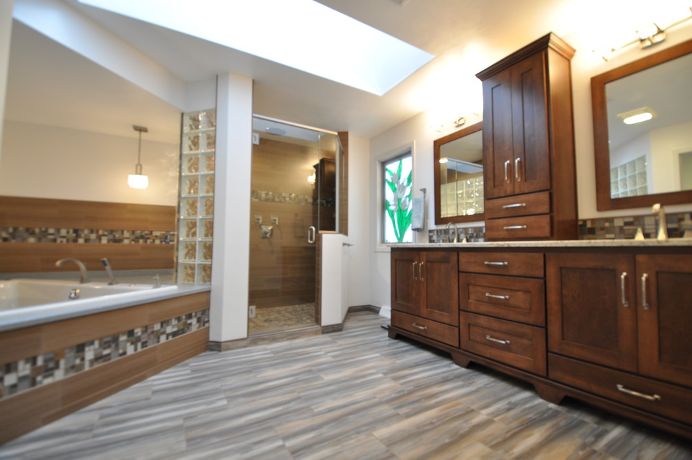 Inspiration for a large contemporary master bathroom in Other with shaker cabinets, dark wood cabinets, a drop-in tub, an alcove shower, brown tile, gray tile, porcelain tile, white walls, porcelain floors, an undermount sink, engineered quartz benchtops, grey floor and a hinged shower door.