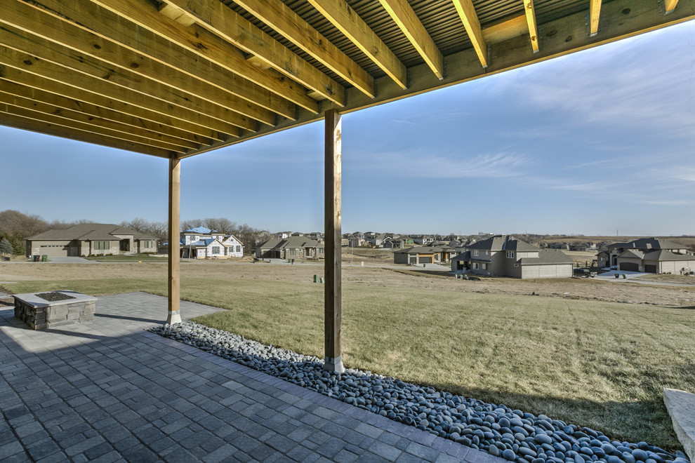 Transitional one-story stucco home design photo in Omaha with a hip roof
