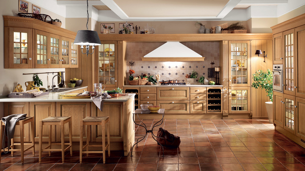 This is an example of a large traditional u-shaped eat-in kitchen in Melbourne with a drop-in sink, raised-panel cabinets, light wood cabinets, quartzite benchtops, multi-coloured splashback, ceramic splashback, stainless steel appliances, porcelain floors and a peninsula.
