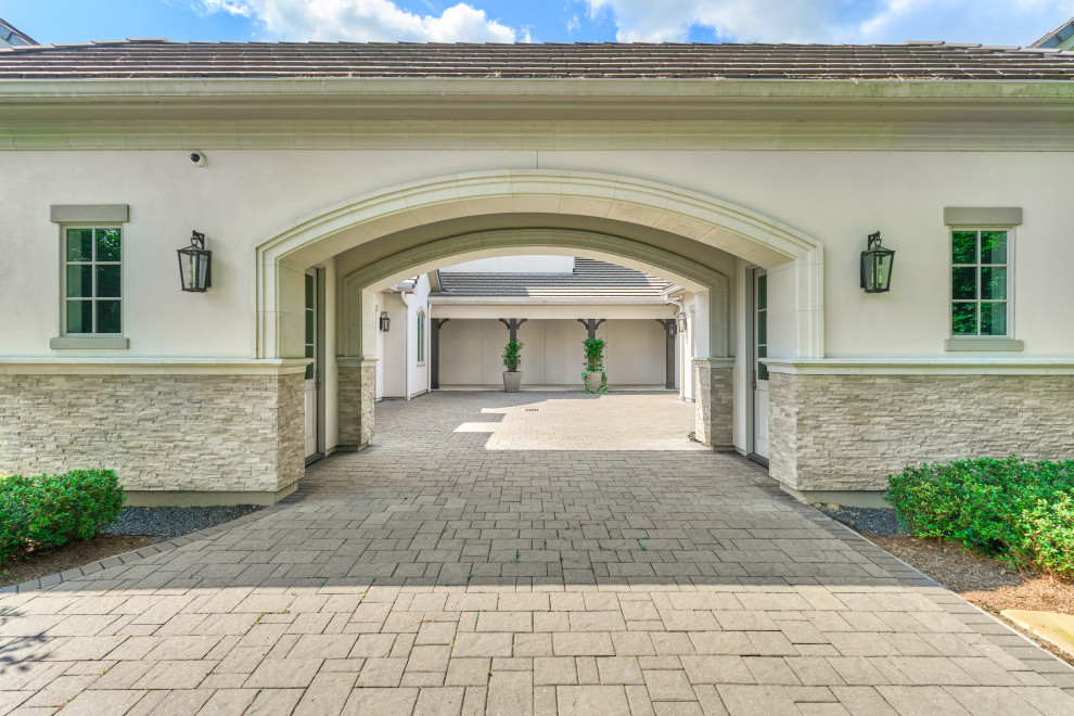 Inspiration for a transitional attached porte cochere remodel in Houston