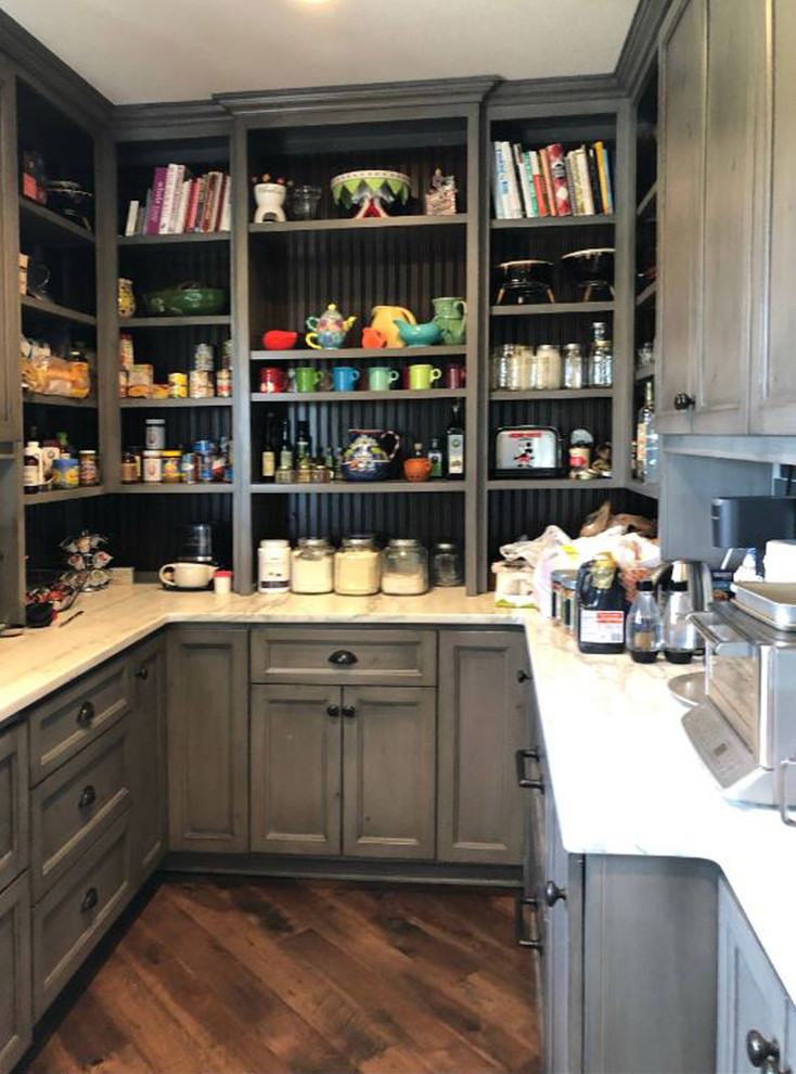 Photo of a mid-sized country u-shaped kitchen pantry in Orange County with recessed-panel cabinets, grey cabinets, marble benchtops, multi-coloured splashback, subway tile splashback, dark hardwood floors, no island, brown floor and white benchtop.