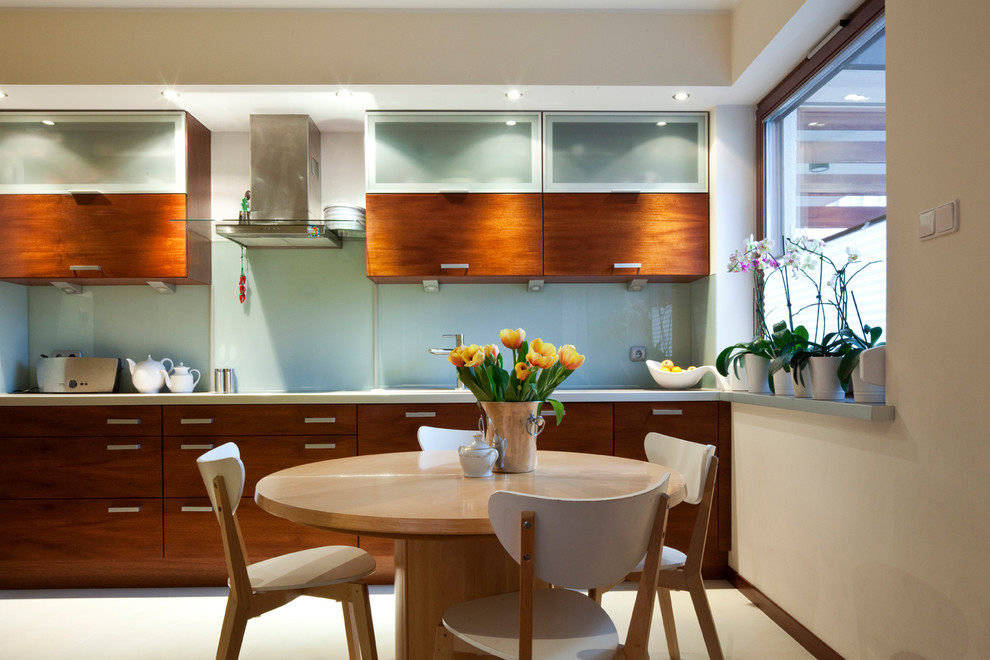 Large modern kitchen/dining combo in London with beige walls, no fireplace and white floor.