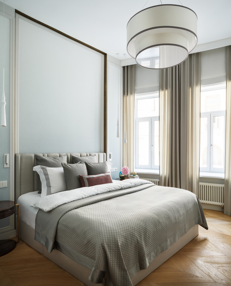 Inspiration for a contemporary master bedroom in Moscow with grey walls and light hardwood floors.