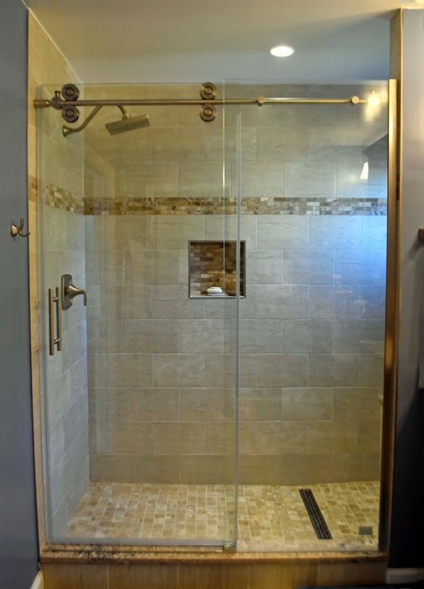 This is an example of a large traditional master bathroom in DC Metro with raised-panel cabinets, medium wood cabinets, an alcove shower, brown tile, travertine, blue walls, an undermount sink, granite benchtops, a sliding shower screen and brown benchtops.