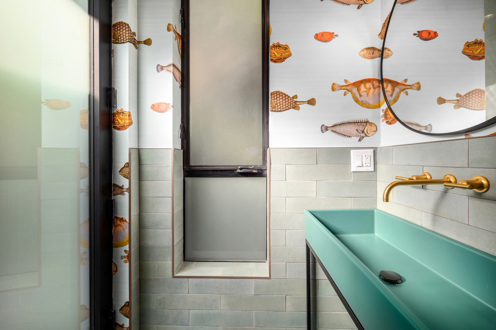 This is an example of a mid-sized beach style 3/4 bathroom in Los Angeles with open cabinets, turquoise cabinets, an alcove shower, a two-piece toilet, gray tile, cement tile, white walls, cement tiles, a vessel sink, white floor, a hinged shower door, a single vanity, a built-in vanity, turquoise benchtops, a niche and glass benchtops.