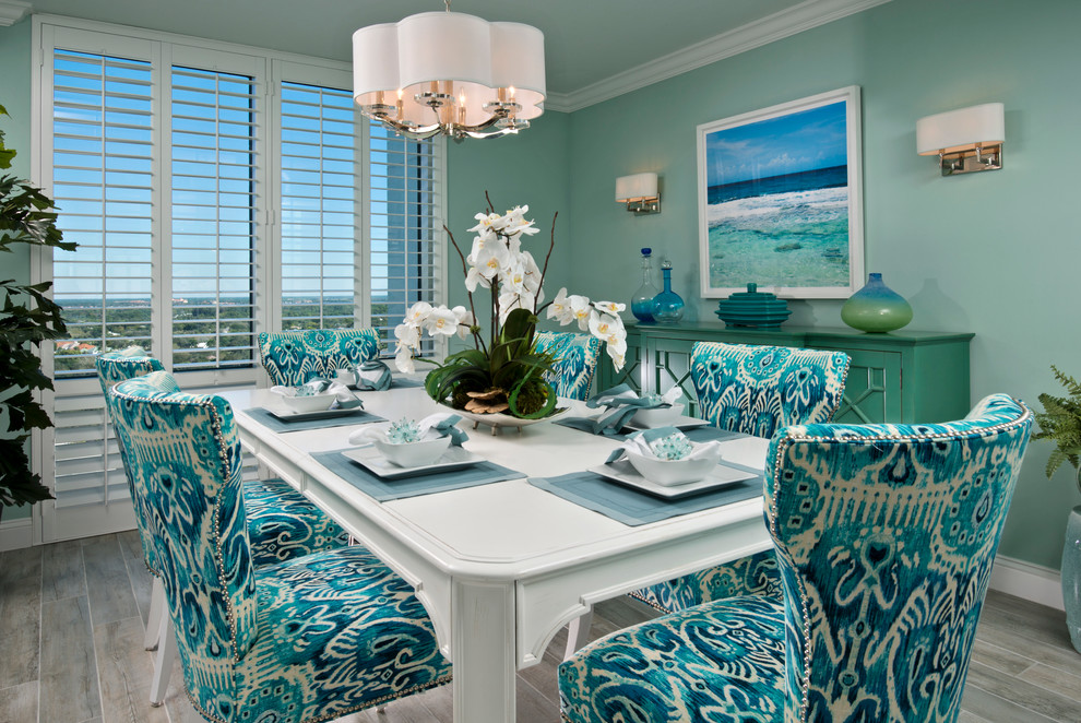 Inspiration for a mid-sized beach style separate dining room in Miami with green walls and light hardwood floors.