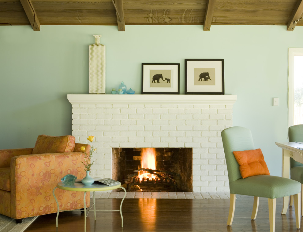 Photo of a country living room in San Francisco with blue walls and a standard fireplace.