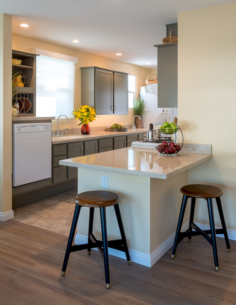 Design ideas for a small arts and crafts galley open plan kitchen in San Diego with an undermount sink, shaker cabinets, green cabinets, quartz benchtops, grey splashback, white appliances, cork floors and a peninsula.