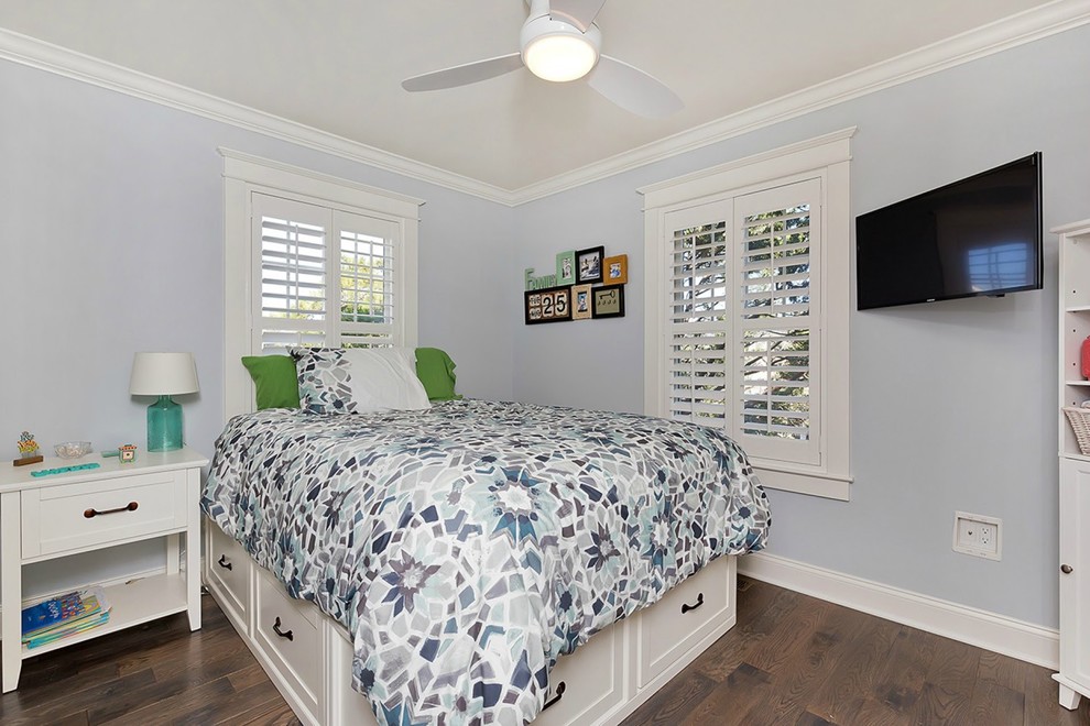 Photo of a mid-sized beach style guest bedroom in New York with blue walls, medium hardwood floors and no fireplace.