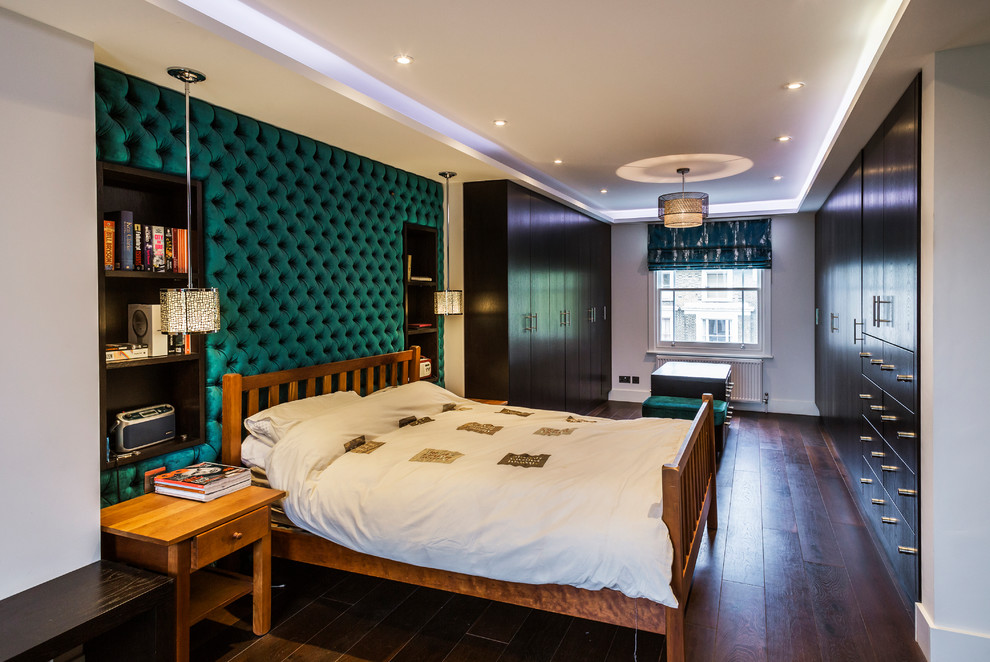 Mid-sized contemporary master bedroom in London with white walls, dark hardwood floors and brown floor.