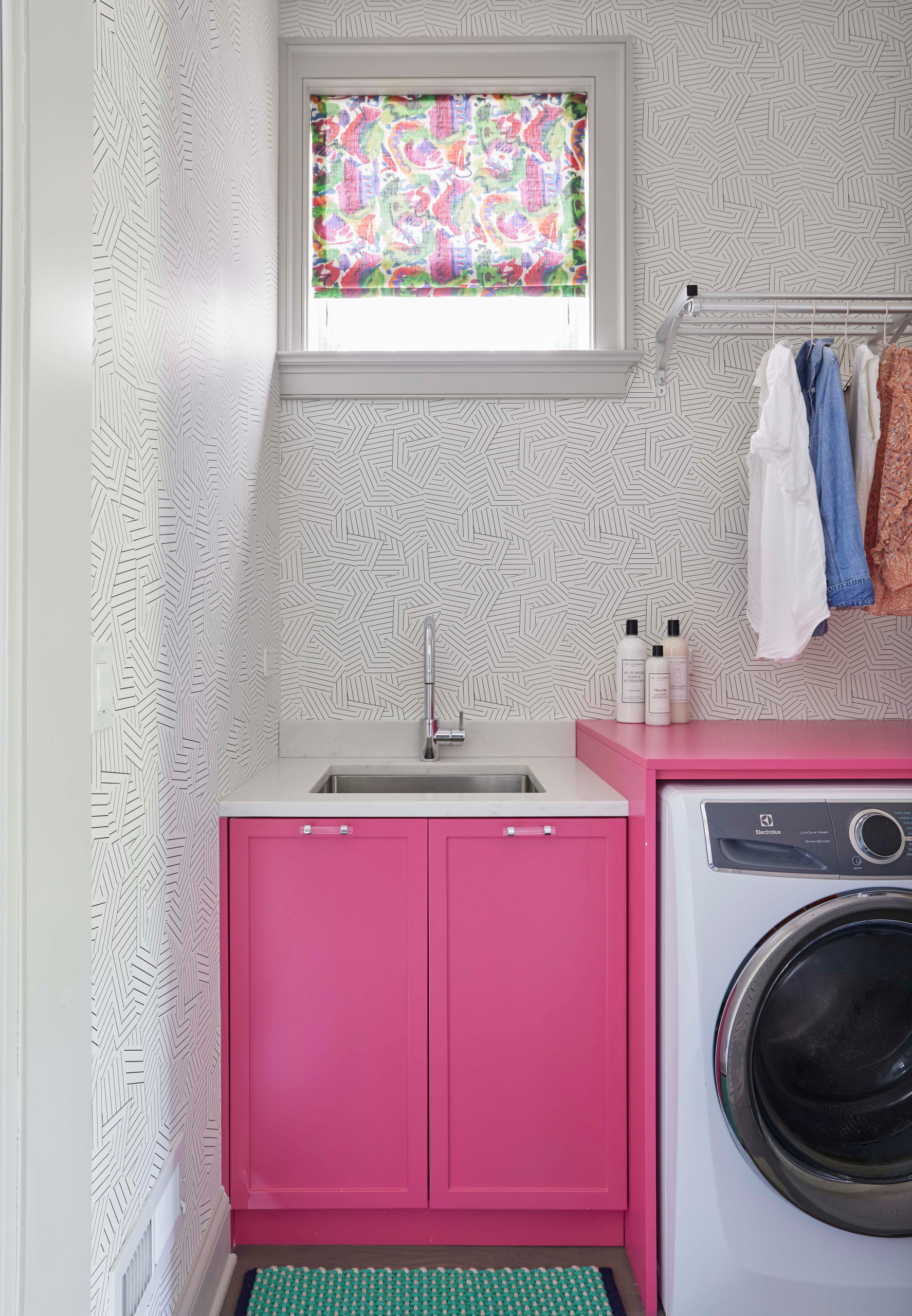 A pink and white iron sitting on top of a table photo – Laundry