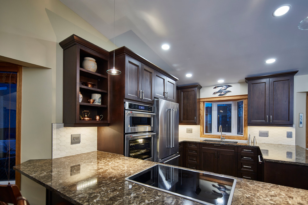 Inspiration for a mid-sized transitional u-shaped porcelain tile eat-in kitchen remodel with an undermount sink, shaker cabinets, dark wood cabinets, quartz countertops, beige backsplash, stone tile backsplash, stainless steel appliances and a peninsula