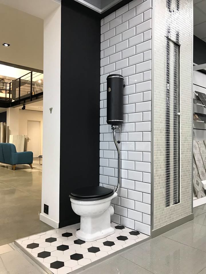 Inspiration for a mid-sized midcentury powder room in Montpellier with beaded inset cabinets, black cabinets, a bidet, multi-coloured tile, terra-cotta tile, grey walls, cement tiles, an undermount sink, laminate benchtops, grey floor and black benchtops.