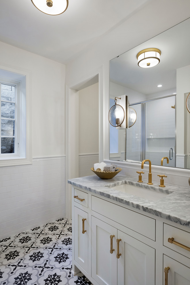 Photo of a large traditional kids bathroom in Minneapolis with beaded inset cabinets, light wood cabinets, a claw-foot tub, a curbless shower, a two-piece toilet, white tile, marble, white walls, mosaic tile floors, a drop-in sink, marble benchtops, white floor, a hinged shower door and white benchtops.