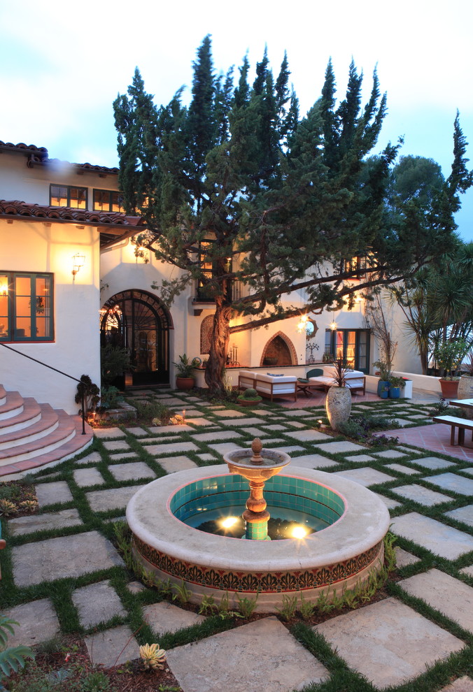 Mediterranean patio in Los Angeles with a water feature.