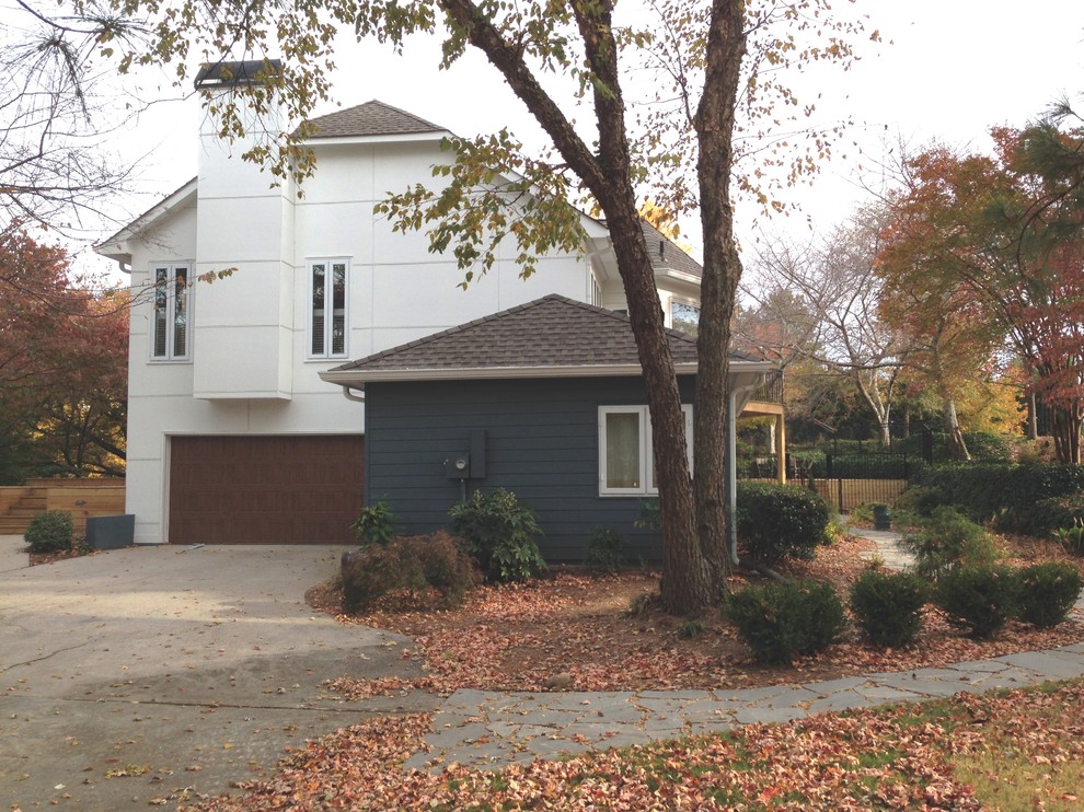 Photo of a large contemporary two-storey white exterior in Atlanta with mixed siding and a gambrel roof.