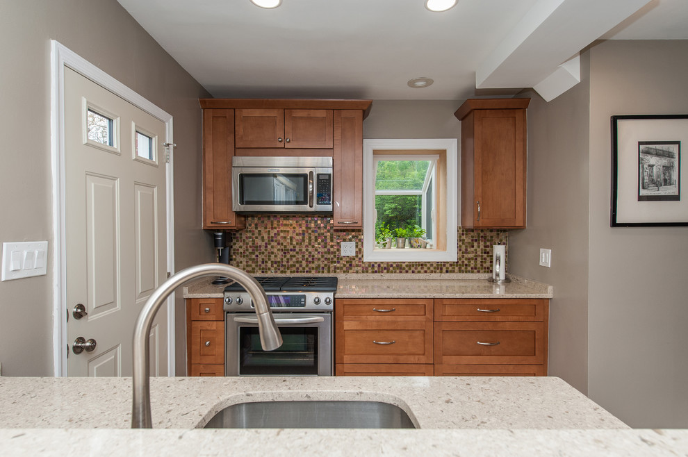 Inspiration for a large transitional galley cork floor eat-in kitchen remodel in DC Metro with an undermount sink, shaker cabinets, brown cabinets, quartz countertops, multicolored backsplash, glass tile backsplash and stainless steel appliances