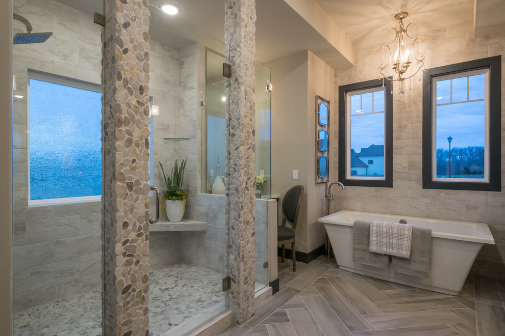Mid-sized transitional master bathroom in Other with recessed-panel cabinets, dark wood cabinets, a drop-in tub, a shower/bathtub combo, a two-piece toilet, brown tile, ceramic tile, grey walls, ceramic floors, an undermount sink, quartzite benchtops and grey floor.