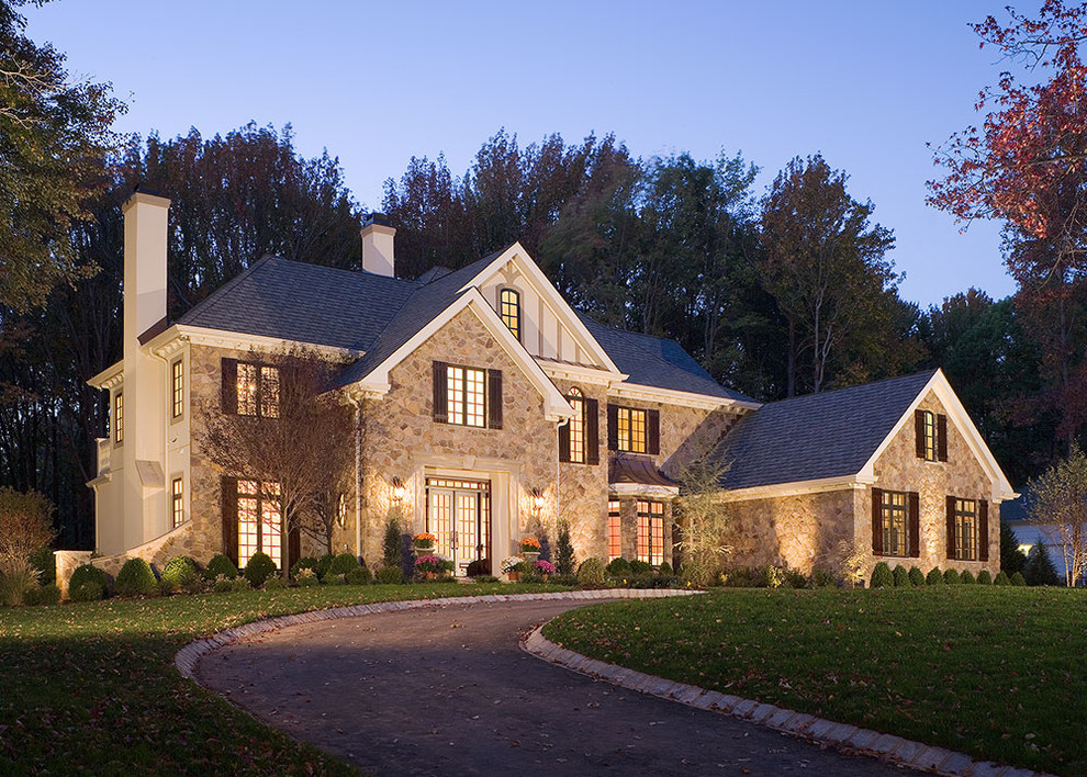 Design ideas for a large traditional two-storey beige exterior in New York with a hip roof and stone veneer.