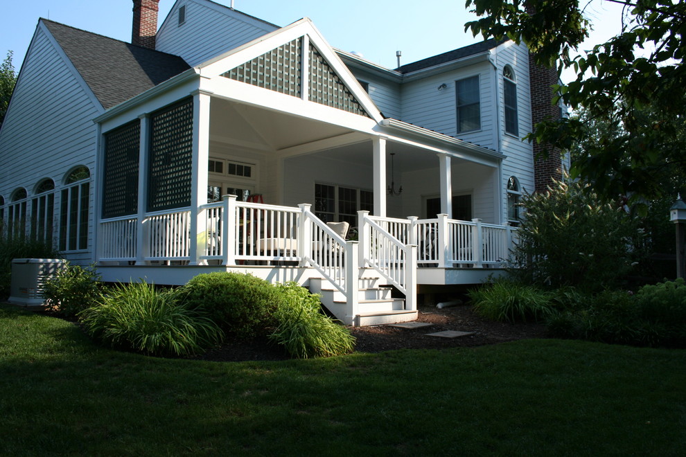 Photo of a large traditional backyard screened-in verandah in New York with decking and a roof extension.