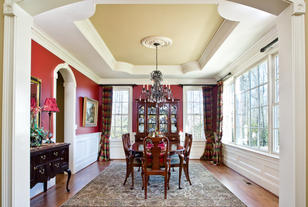 Design ideas for a large traditional separate dining room in Other with red walls and medium hardwood floors.
