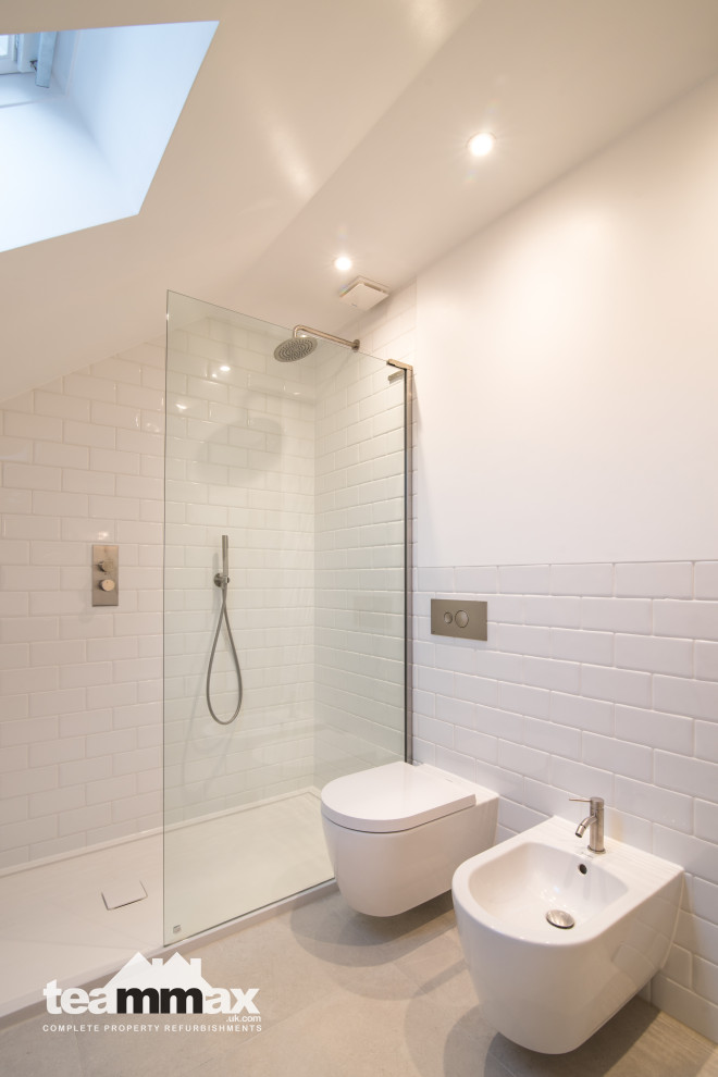 This is an example of a large contemporary 3/4 bathroom in Hertfordshire with an open shower, a wall-mount toilet, porcelain tile, porcelain floors and an open shower.