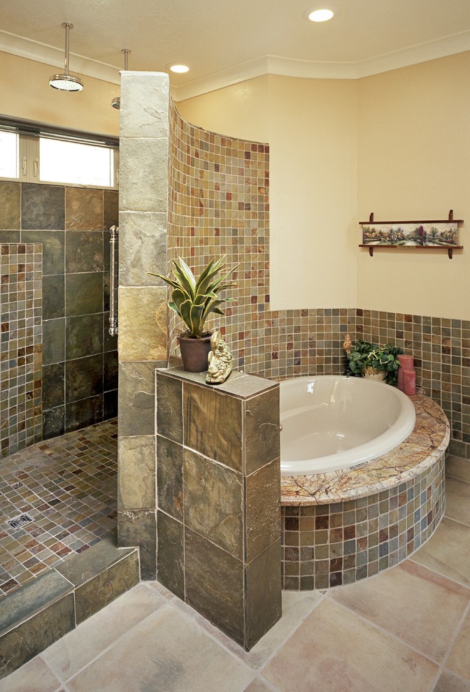 This is an example of a traditional master bathroom in Albuquerque with shaker cabinets, medium wood cabinets, granite benchtops, a drop-in tub, an alcove shower, beige tile, brown tile, gray tile, multi-coloured tile, orange tile, ceramic tile and an open shower.