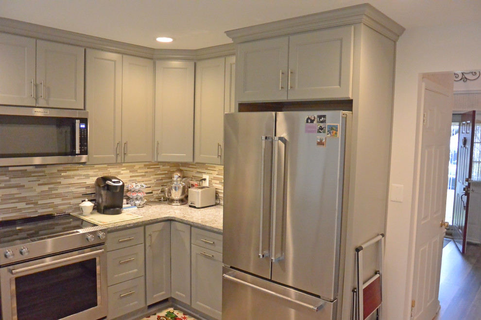 Inspiration for a small transitional u-shaped vinyl floor and brown floor eat-in kitchen remodel in DC Metro with an undermount sink, shaker cabinets, gray cabinets, granite countertops, gray backsplash, mosaic tile backsplash, stainless steel appliances, a peninsula and gray countertops