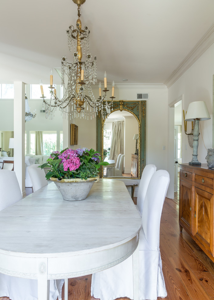 Inspiration for a mid-sized traditional separate dining room in New Orleans with white walls, medium hardwood floors, no fireplace and brown floor.