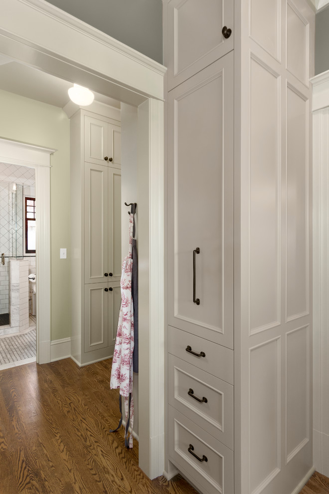 Enclosed kitchen - mid-sized transitional u-shaped medium tone wood floor and brown floor enclosed kitchen idea in Seattle with an undermount sink, beaded inset cabinets, gray cabinets, quartzite countertops, gray backsplash, ceramic backsplash, paneled appliances and a peninsula