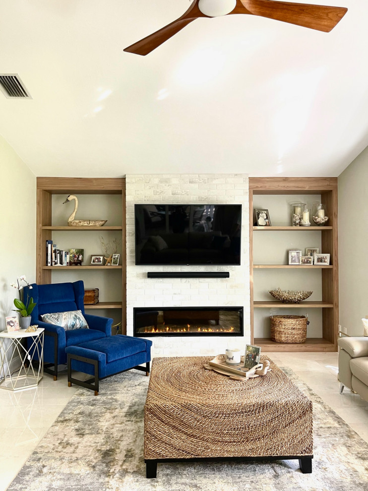 Photo of a mid-sized beach style formal enclosed living room in Miami with a hanging fireplace, a tile fireplace surround and a built-in media wall.